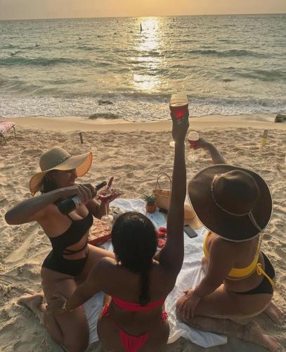 a group of women sitting on the beach at AcapulcoBeach in Playa Blanca
