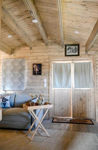 a living room with a couch and a table at Stylish Tiny Home with Fire Pit in Moss Vale in Moss Vale