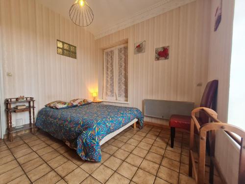 a bedroom with a bed and a chair in it at Gîte Parroy, 4 pièces, 6 personnes - FR-1-584-29 