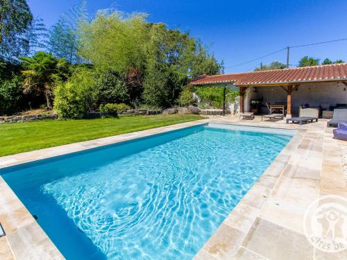 une piscine dans l'arrière-cour d'une maison dans l'établissement Roulotte climatisée avec piscine et jardin - FR-1-622-54, à Vihiers