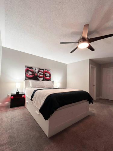 a bedroom with a bed and a ceiling fan at Room in Oshawa, 24/7 Security, Free Parking in Oshawa