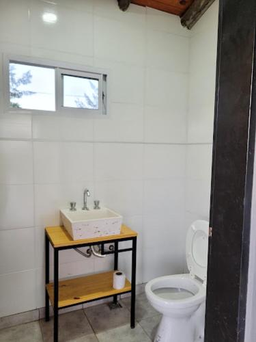 a bathroom with a sink and a toilet at Ikigai in Concepción del Uruguay