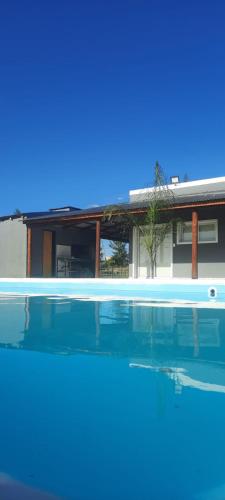 a swimming pool in front of a house at Ikigai in Concepción del Uruguay