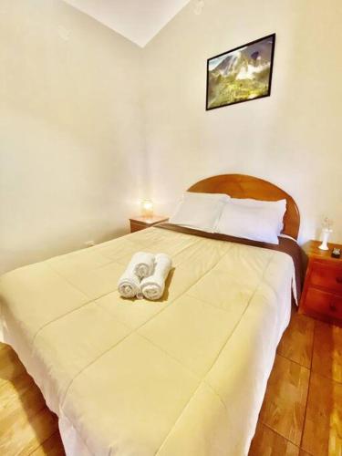 a bedroom with a bed with two towels on it at Casa de campo en Urubamba in Maras