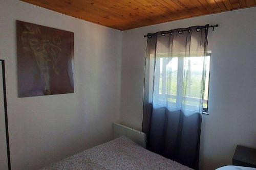 a bedroom with a bed and a window with a curtain at Holiday house with a parking space Tuheljske Toplice, Zagorje - 23188 in Tuhelj