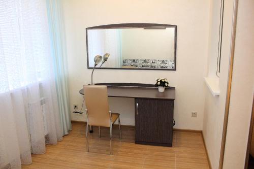 een bureau met een spiegel en een tafel met een stoel bij Hotel Complex Park hotel D-grad in Dimitrovgrad