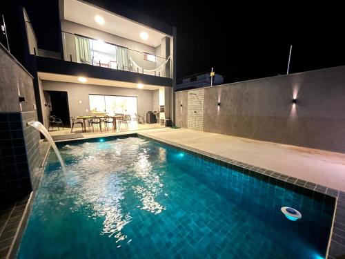 a swimming pool in the middle of a house at Casa Sofia Milagres - 200 m da Praia in São Miguel dos Milagres
