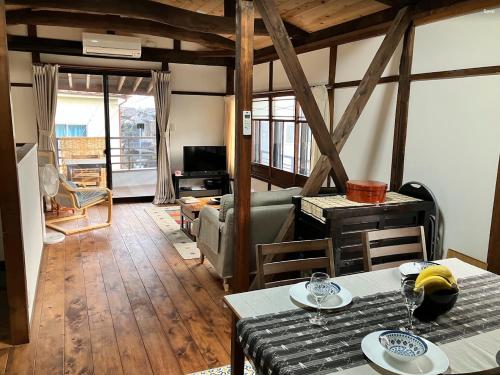 a living room with a table and a couch at Kurodani House in Kyoto