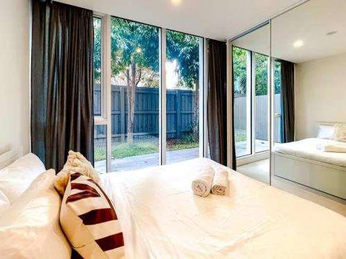 a bedroom with a bed with two slippers on it at BPM Brighton APT with Garden LG1 in Melbourne