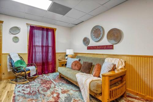 a living room with a couch and a table at Log Cabin, Hot Tub, Fireplace, Pool Table & Views! in Sevierville