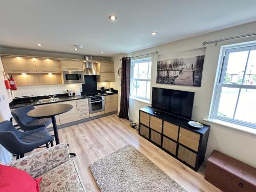 a room with a kitchen and a living room at The Cosy Retreat in Filey