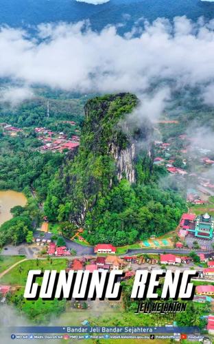 a magazine cover of a mountain with a town at Homestay Jeli - Cattleya Inn Muslim in Jeli
