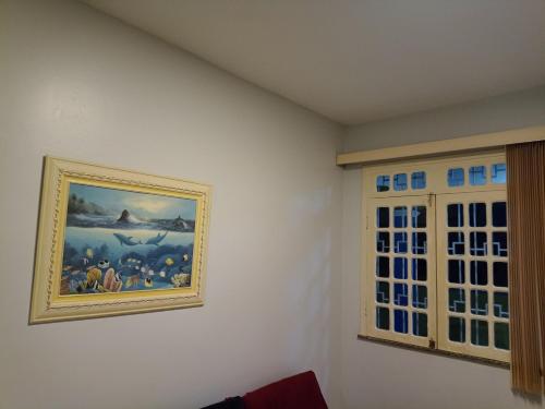 a painting hanging on a wall in a room at Condomínio Mares do Sul in Salinópolis