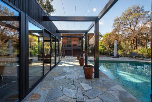 an external view of a house with a swimming pool at Atlas Retreat in Shoreham