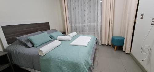 En eller flere senge i et værelse på Laguna del mar La Serena Piso 1