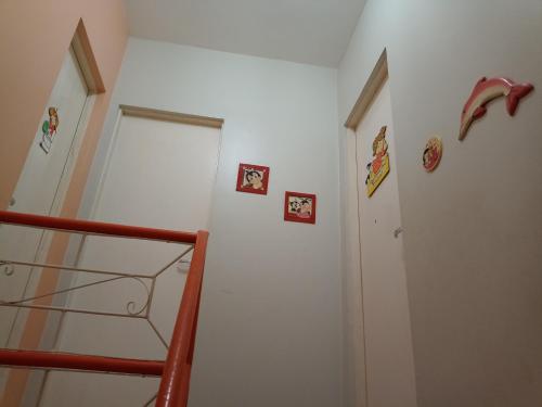 a room with a staircase with pictures on the wall at Condomínio Mares do Sul in Salinópolis