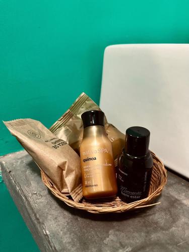 a basket with two bottles of soap on a table at Jimbaran Pousada & Bristrot in Maragogi