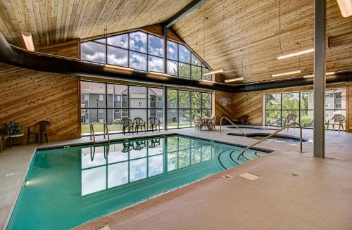 a large indoor swimming pool in a building with windows at Comfy Condo With Amazing View of Gatlinburg and the Smokies in Gatlinburg