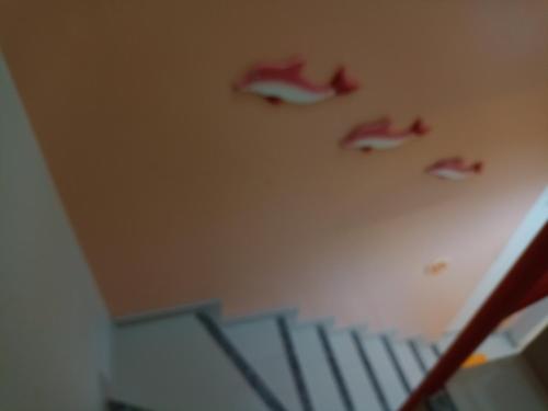 a staircase in a room with red shoes on the wall at Condomínio Mares do Sul in Salinópolis