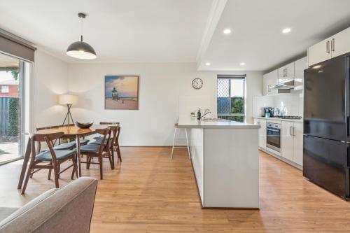 a kitchen and dining room with a table and chairs at Churchill Condo in Prospect