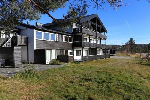 a large house with a large yard in front of it at Bortelid Booking in Tjaldal