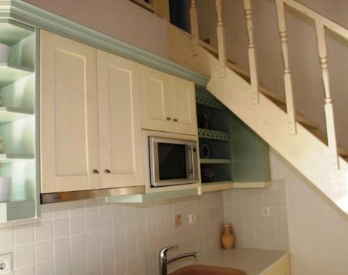 a kitchen with a sink and a microwave at Caldera Studios in Astypalaia Town