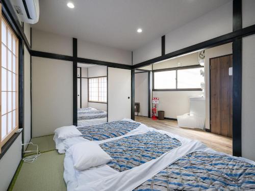 a bedroom with two beds in a room at Familia Heiwajima in Tokyo