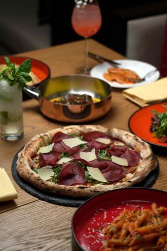 a table with two pizzas on a table at Fairmont Riyadh in Riyadh