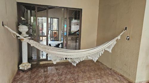 a hammock hanging from a wall in a room at Hostel Sol e Luar in Franca