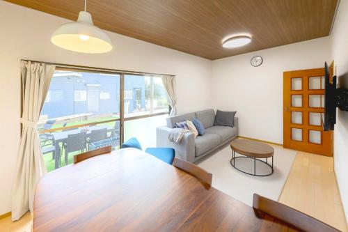 a living room with a couch and a table at ANGO Kujukuri II in Katakai