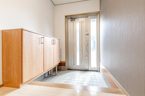 an empty room with a door and a hallway at ANGO Kujukuri II in Katakai