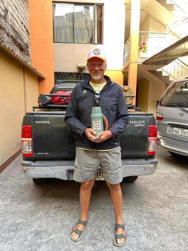 a man is standing in front of a truck at Hostal La Terraza in Quito
