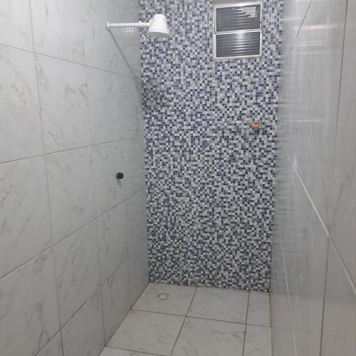 a bathroom with a shower with a glass door at Casa de praia in Sirinhaém