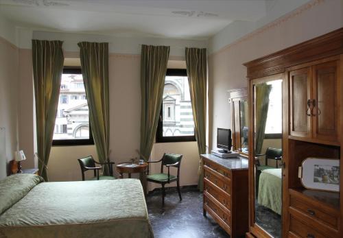 a bedroom with a bed, chair, desk and a window at B&B A Florence View in Florence