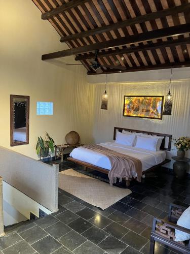 a bedroom with a large bed in a room at Pao Homes - Riverside House in Hoi An