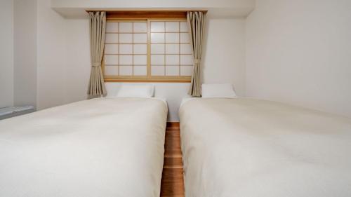 Postel nebo postele na pokoji v ubytování Hotel Obihiro Hills