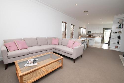 a living room with a couch and a coffee table at Villa 88 - Stylish, Modern, Fresh & Light in Orange