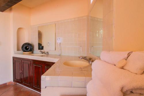a bathroom with a sink and a mirror at Hotel Chocolate Suites in Guanajuato