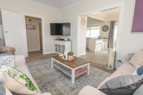 a living room with a couch and a coffee table at Nile Cottage Cosy & Convenient, Close to CBD in Orange