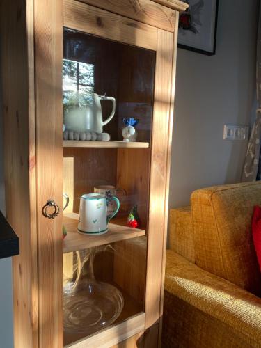 a wooden hutch with cups and dishes in it at Cottage Bad Ischl in Bad Ischl