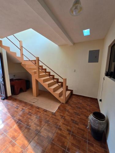 a staircase in a room with a wooden floor at Casa Nazareno in Antigua Guatemala