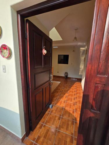 an open door to a room with a television at Casa Nazareno in Antigua Guatemala