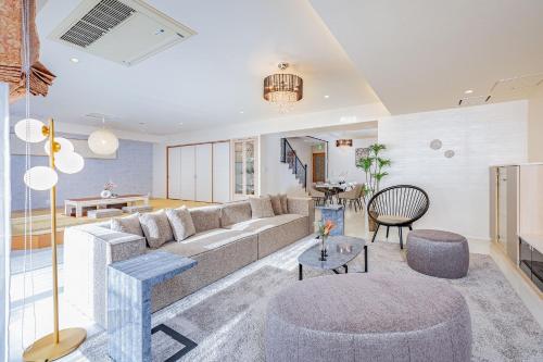a living room with a couch and a table at JAPAVISTA Xenith Premium in Osaka