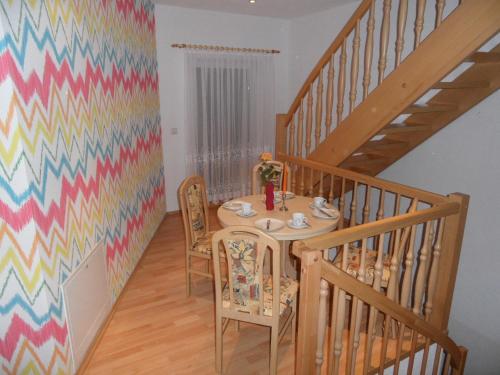 a dining room with a table and a colorful wall at Ferienwohnung an der Therme in Bad Schandau