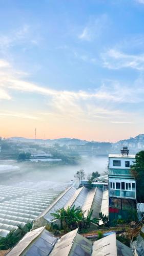 a view of a misty river with a building at Golden Apple Villa Đà Lạt in Khu Chi Lăng