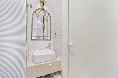 a bathroom with a sink and a mirror at Gyeongju Hotel Gonggan in Gyeongju