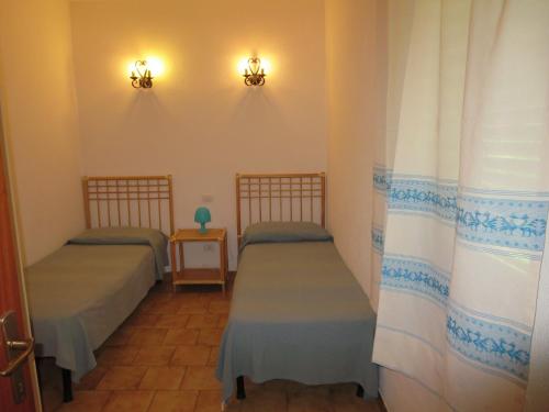 A bed or beds in a room at Villetta Sunrise 35