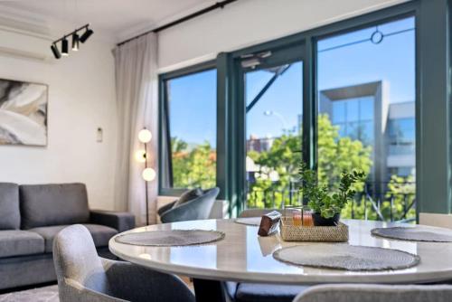 a living room with a table and chairs at Cosy Apt in Subiaco with Free Parking in Perth
