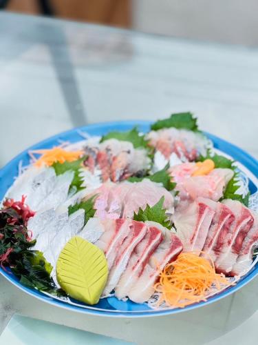 a blue plate of sushi on a table at オーシャンフロント館山 in Tateyama