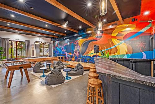 a room with a colorful mural on the wall at Howzit Hostels in Wailuku